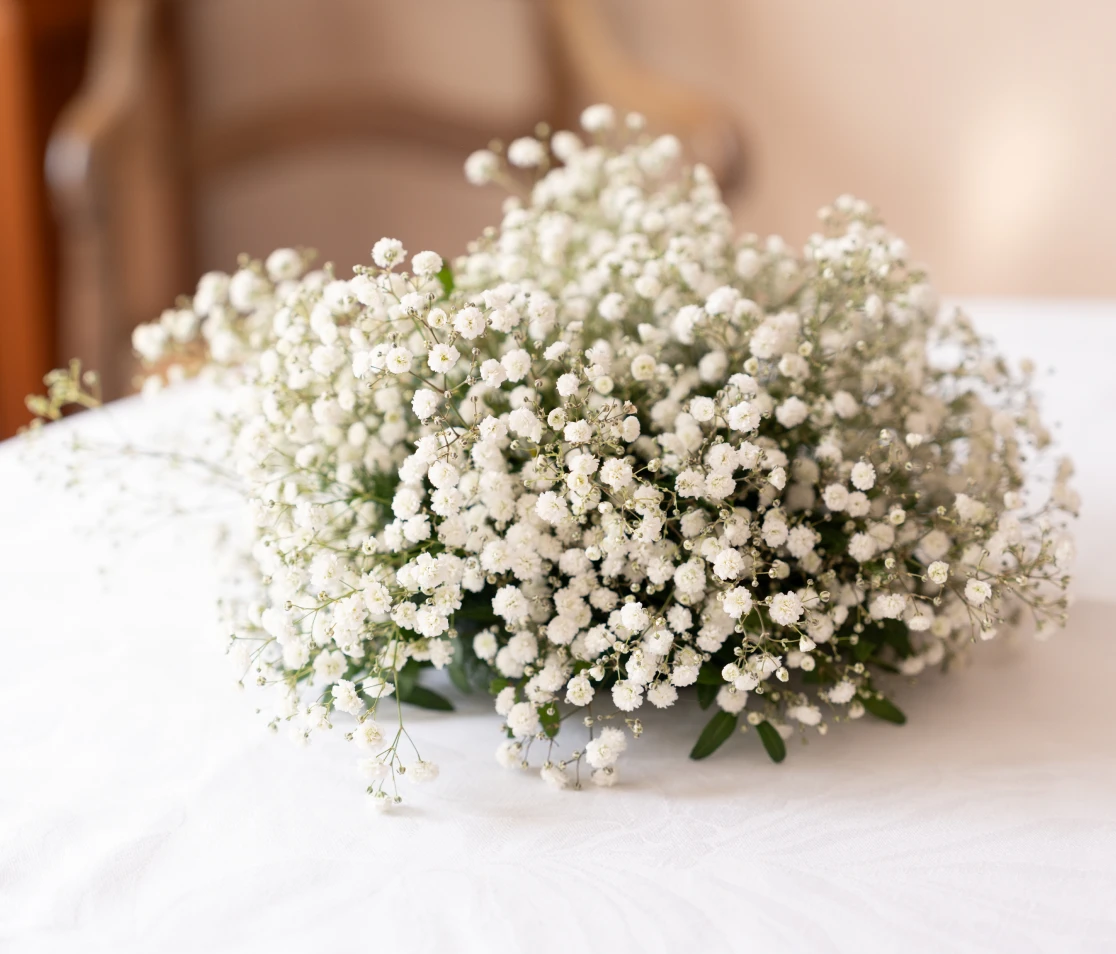 Baby's breath centerpiece on white cloth